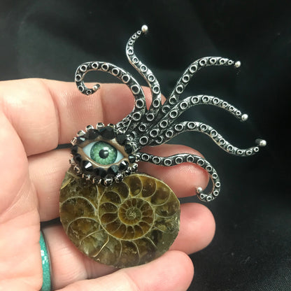 Ammonite Fossil Brooch: Surreal Green Eye Rhinestone Pin