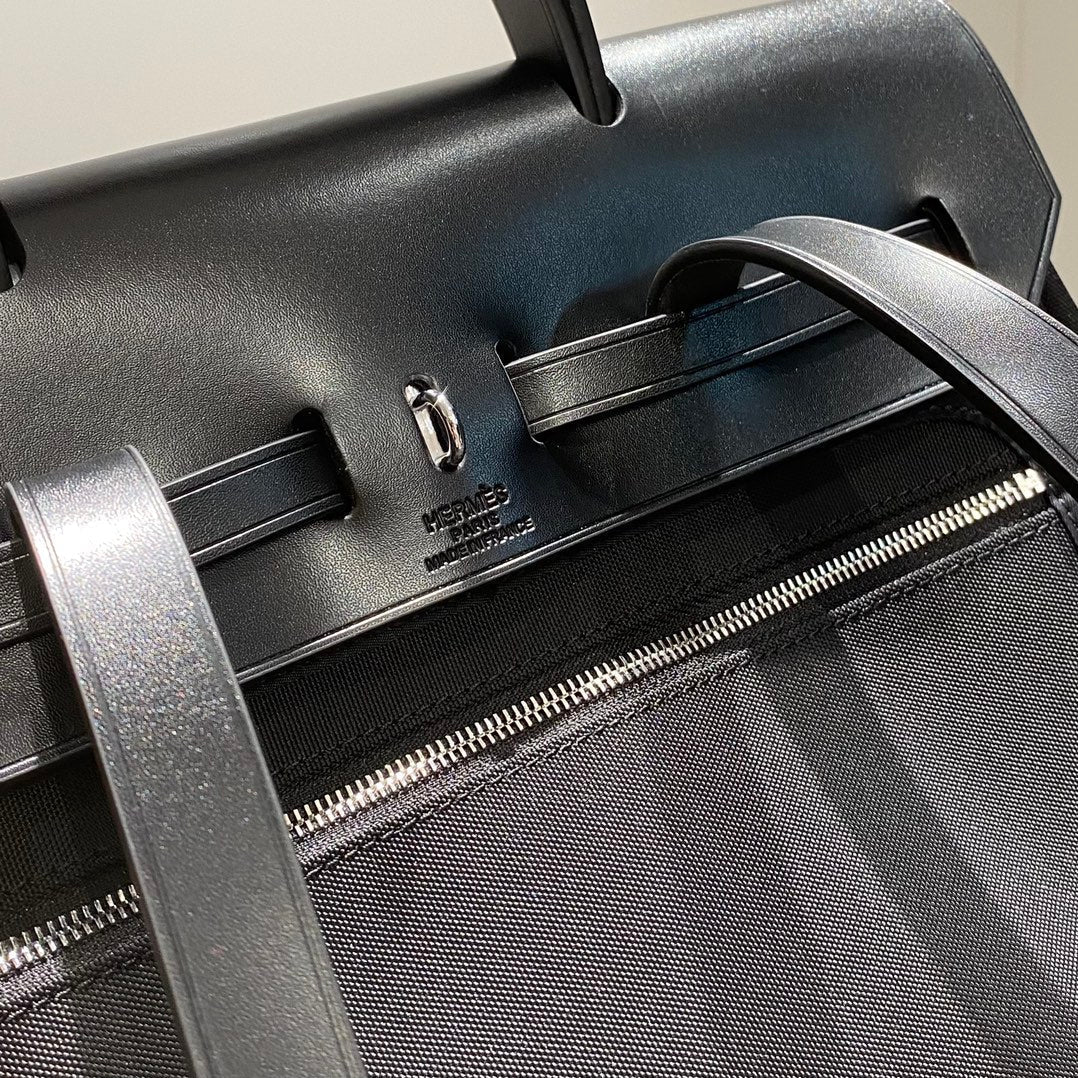 HERBAG A DOS ZIP RETOURNE BACKPACK 29 IN BLACK CANVAS AND CALFSKIN